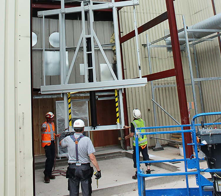 Workers installing mast lift