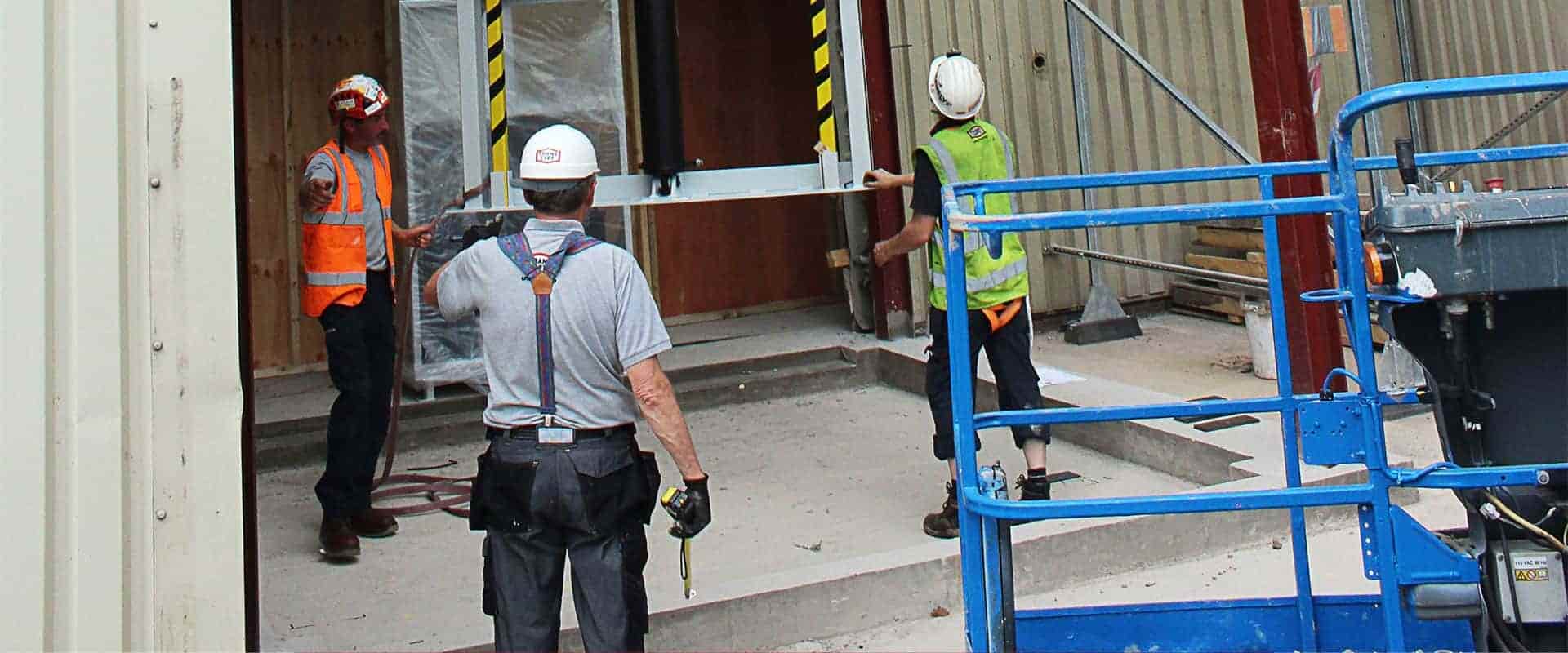 workers installing translyft mast lift 